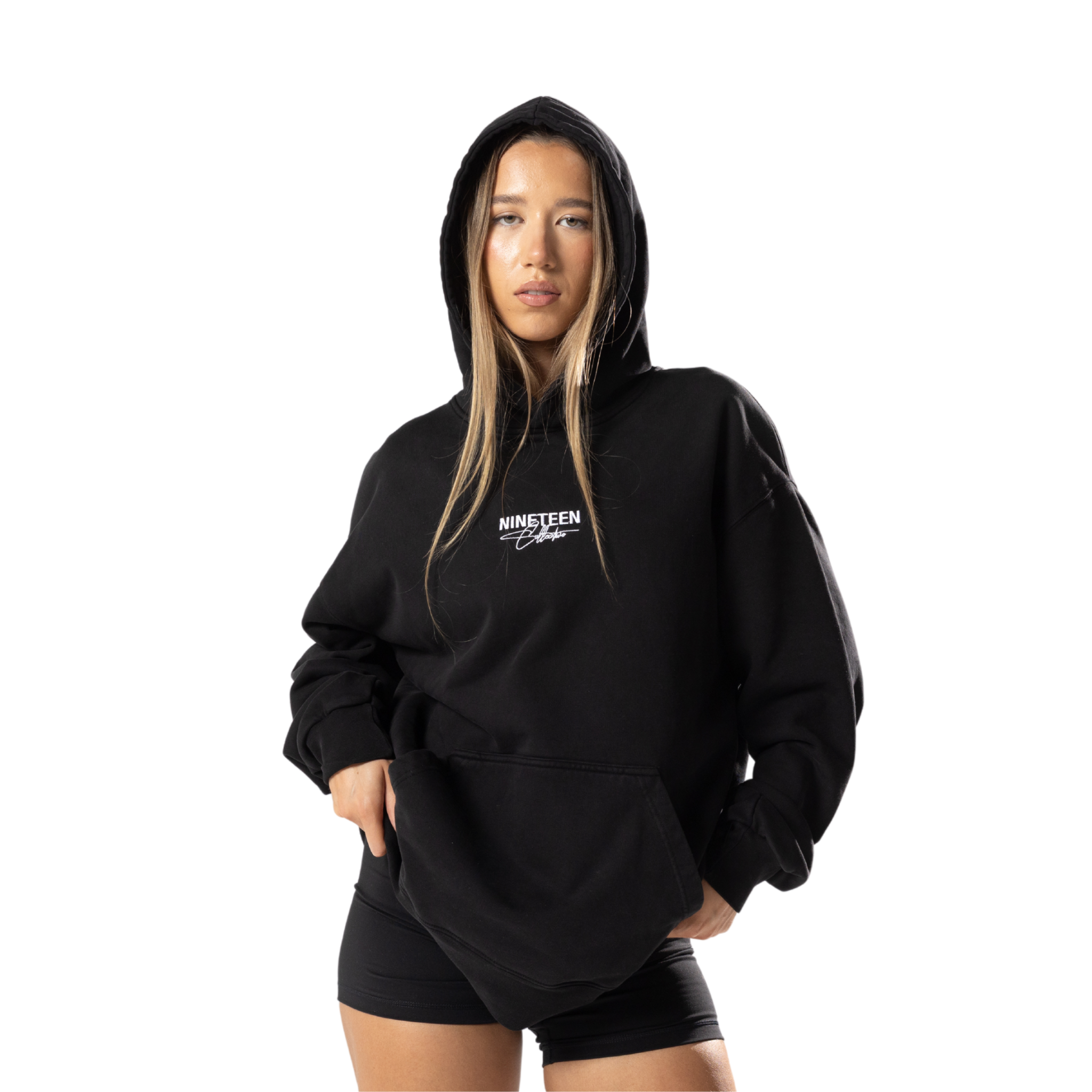 Front on view of model wearing Nineteen Collective organic hoodie in natural light